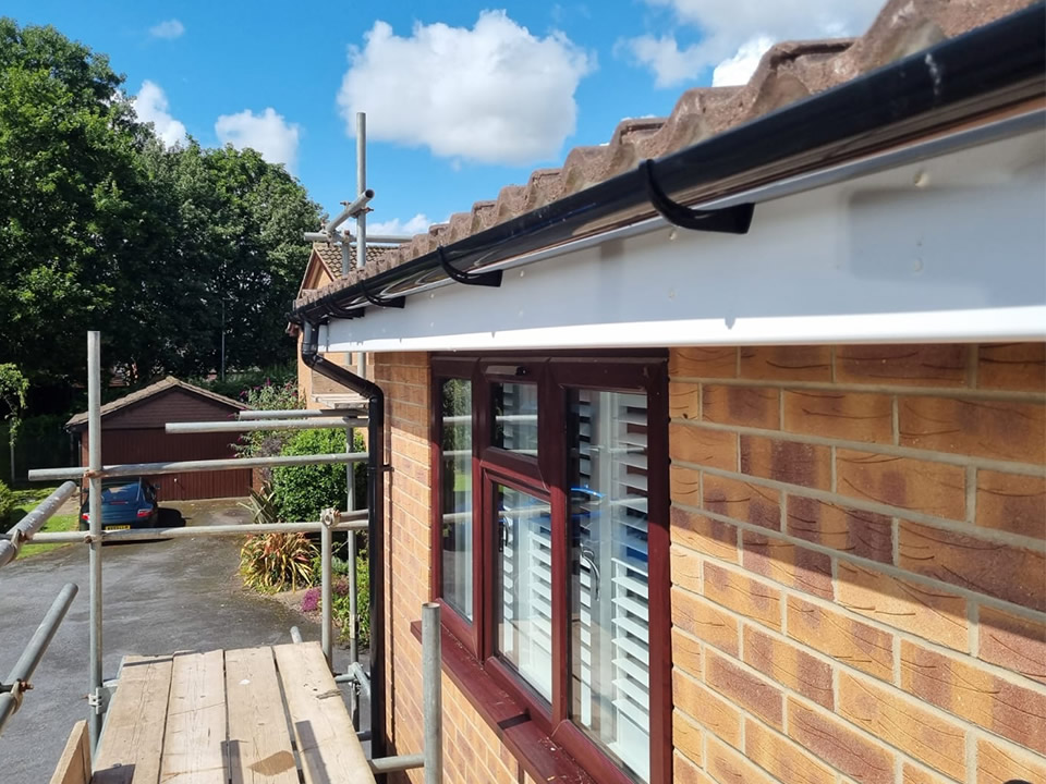Roofing contractor on tiled roof